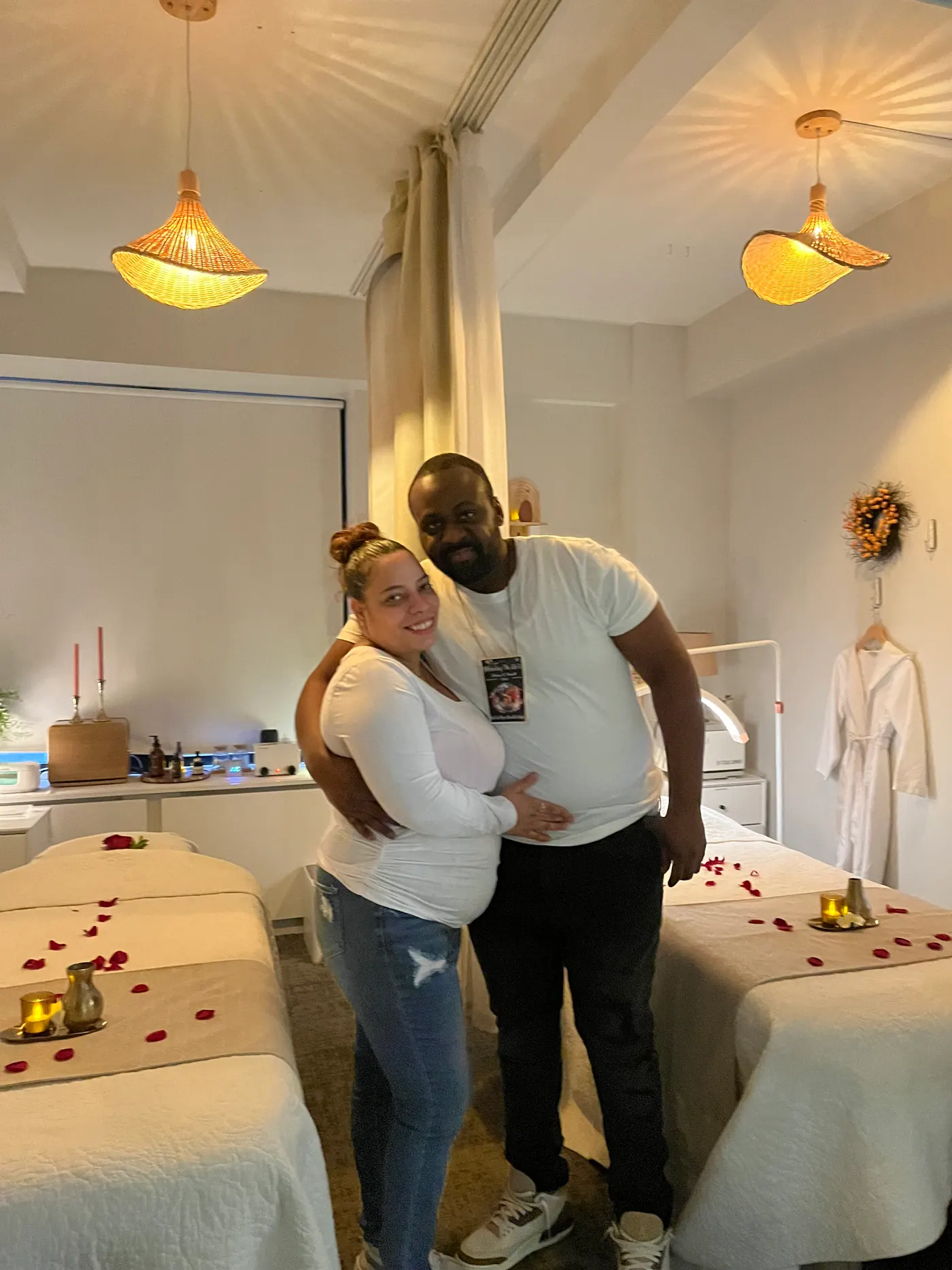A happy couple embracing in the petal-strewn couples suite