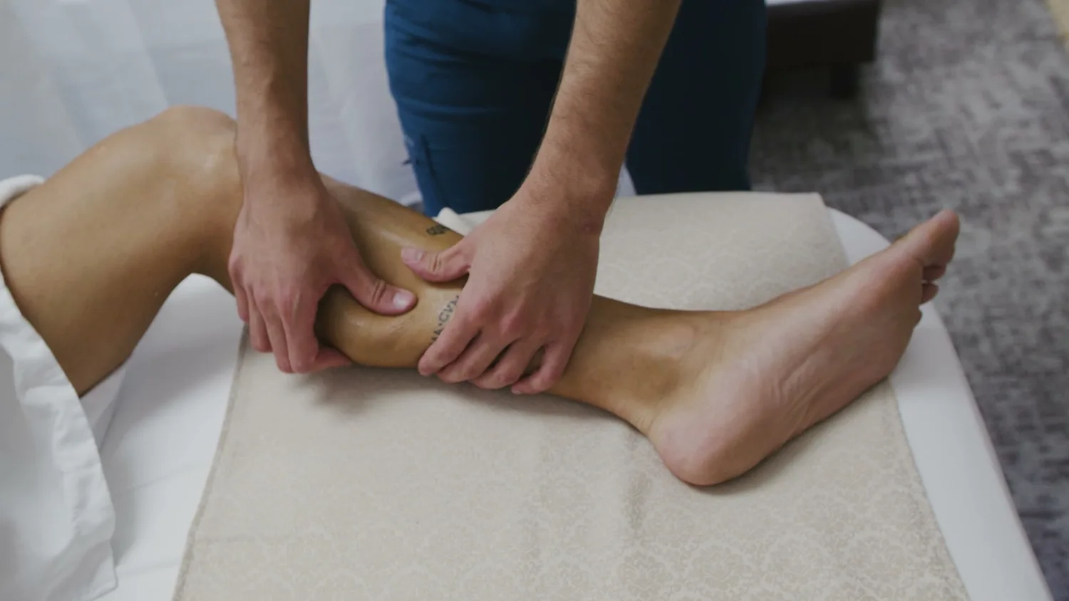 Therapist working pressure points of the foot and calf
