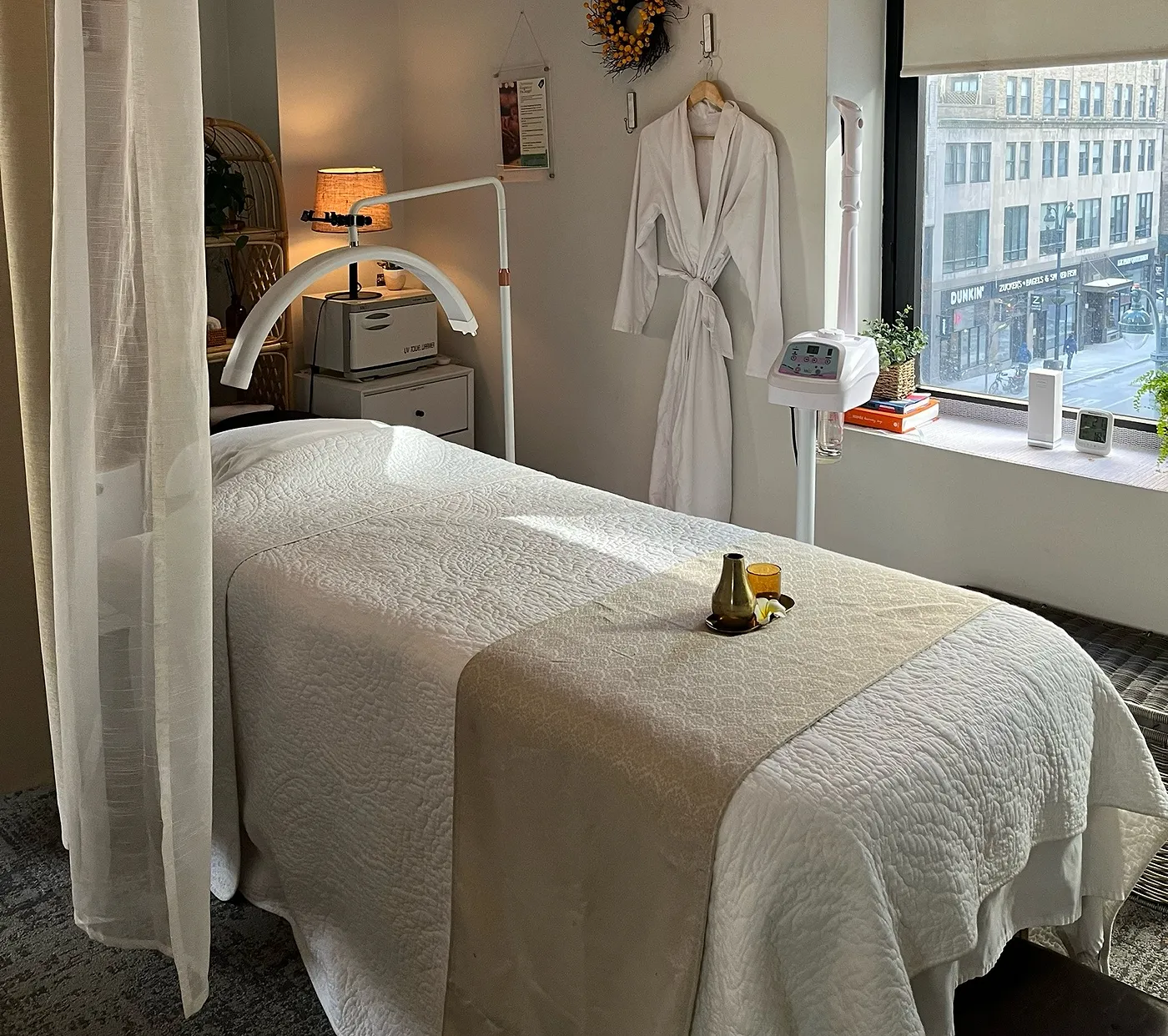 Our treatment room — a warm robe and a bed by the window