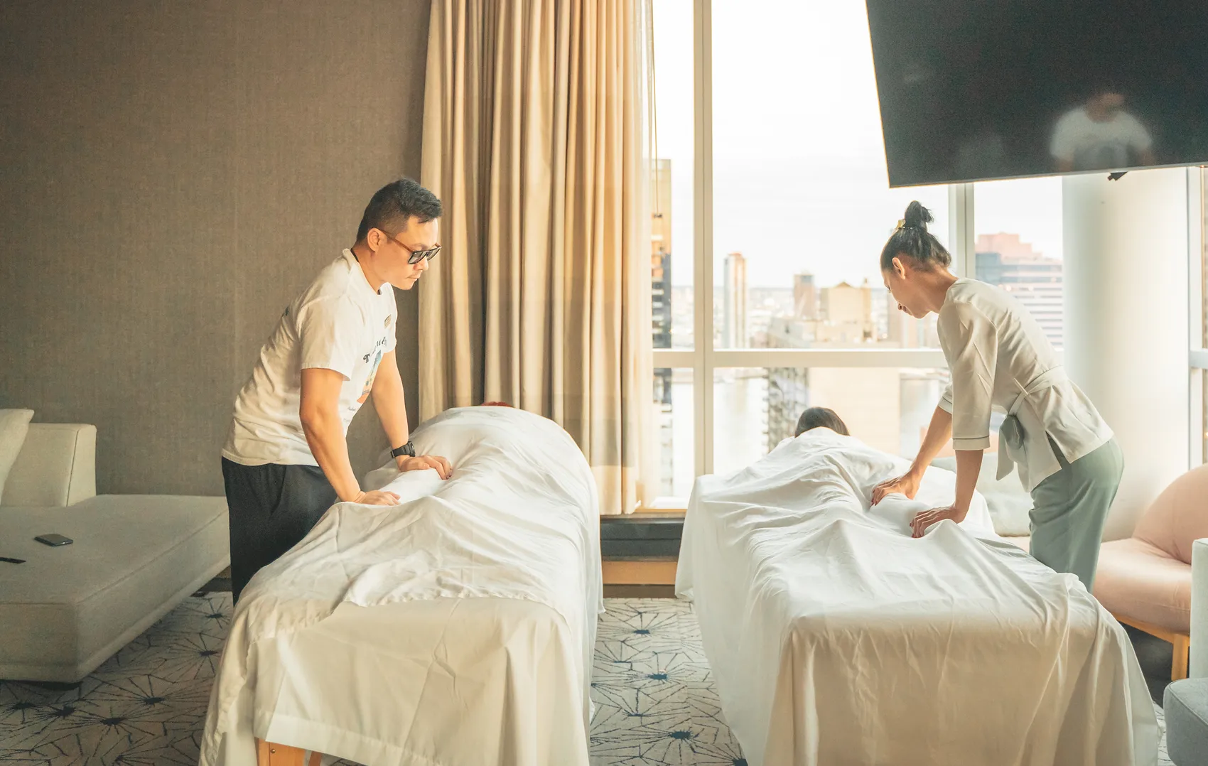 Our therapists preparing an in-room couples session at the hotel, high above Midtown